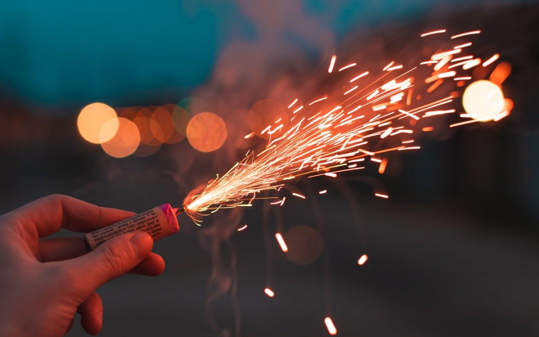 Close-up of a person holding a firecracker.