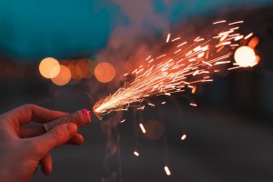 Close-up of a person holding a firecracker.